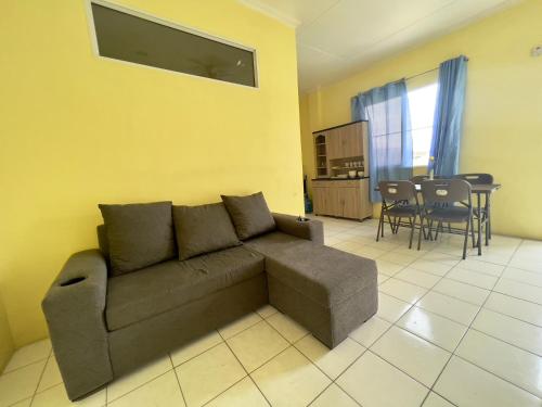 a living room with a couch and a table at Emerald Apartments INC in Georgetown