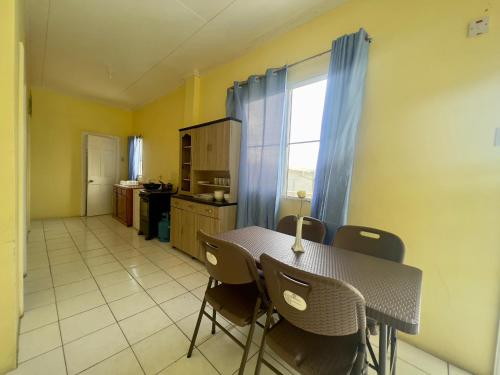 a kitchen and dining room with a table and chairs at Emerald Apartments INC in Georgetown