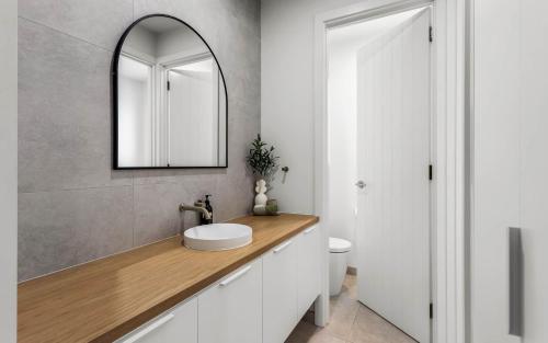 a bathroom with a sink and a mirror at Golden Views at Normanville 36 Union Road in Normanville