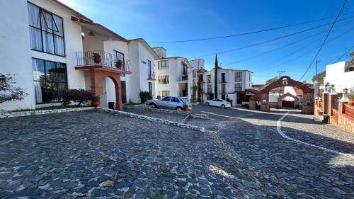 a cobblestone street in a town with buildings at Villas de la Montaña in Taxco de Alarcón