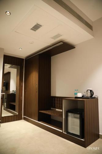 a living room with a fireplace and a television at Belvedere Suites in Greater Noida