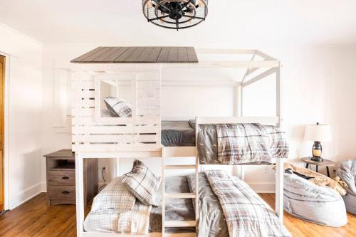a white bunk bed with two beds in a room at Golden Acres Ranch Hot Tub+Gameroom+Creek & wifi in Highlands