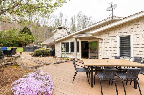 a wooden deck with a table and chairs on a house at Golden Acres Ranch Hot Tub+Gameroom+Creek & wifi in Highlands