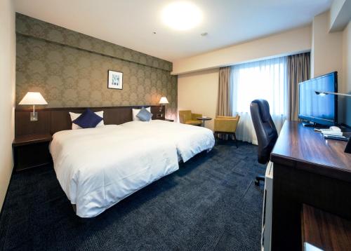 Säng eller sängar i ett rum på Daiwa Roynet Hotel Kobe Sannomiya