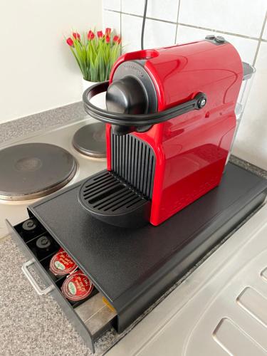 a red mixer sitting on top of a counter at Charmant studio in Binche