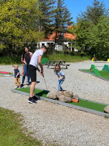a man playing with a little girl in a park at Skagen Strand Holiday Center in Hulsig