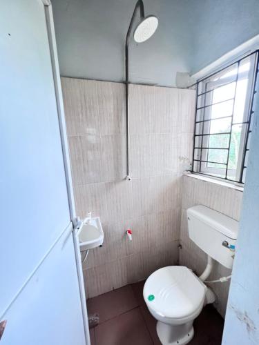 a bathroom with a toilet and a sink at A Home Away From Home in Mawere