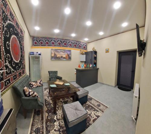 a living room with a couch and a table at Al-Hilal Hostel in Samarkand