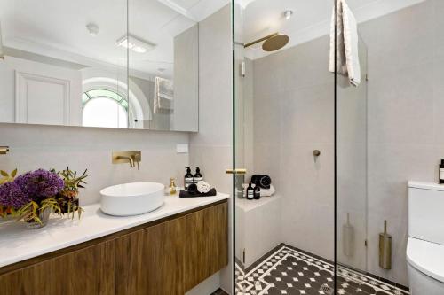 a bathroom with a sink and a shower at Botanic Loft in Adelaide