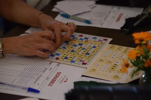 a person playing a board game on a desk at Le Cedrus Hotel in Al Arz
