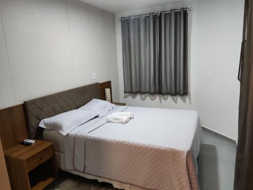a bedroom with a bed with a towel on it at Casa de Veraneio na Praia do Francês in Marechal Deodoro