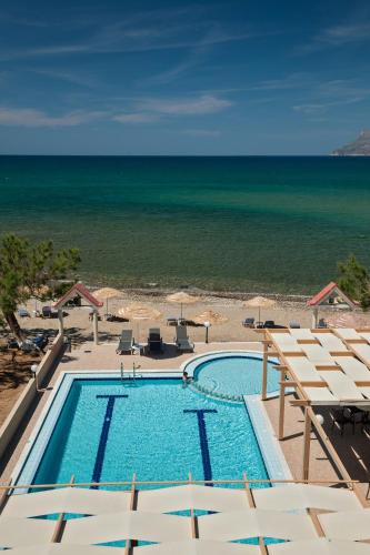 a swimming pool with the ocean in the background at Mesogios Beach in Kissamos