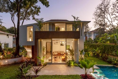 a house with a pool in front of it at La Macedo, Luxury 3 BHK Villas in Assagao, with Private Pool, Garden, Terrace, Parking, Security in Mapusa