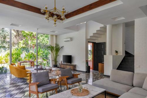 a living room with a couch and chairs at La Macedo, Luxury 3 BHK Villas in Assagao, with Private Pool, Garden, Terrace, Parking, Security in Mapusa