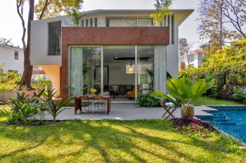 a house with a pool and a yard at La Macedo, Luxury 3 BHK Villas in Assagao, with Private Pool, Garden, Terrace, Parking, Security in Mapusa