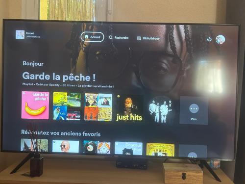 a large television screen with a picture of a woman at Domaine Plan des Devens in Roussillon