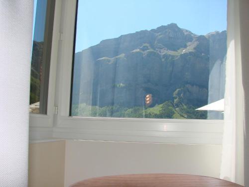 a window with a view of a mountain at Hotel Restaurant Flaschen in Albinen