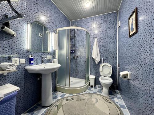 a bathroom with a shower and a toilet and a sink at FRОDО - Cozy as a home for 4-6 persons in Tashkent