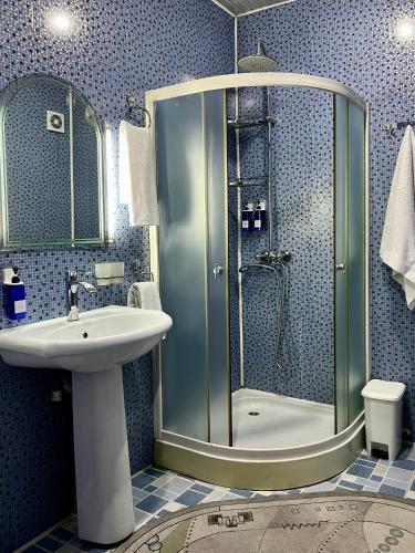 a bathroom with a shower and a sink at FRОDО - Cozy as a home for 4-6 persons in Tashkent