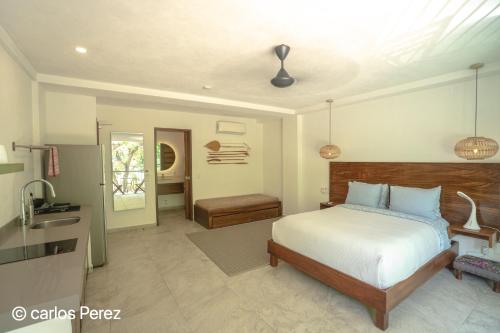 a bedroom with a bed and a sink in it at Hotel Puerto Sayulita in Sayulita