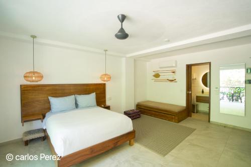 a bedroom with a bed and a bathroom at Hotel Puerto Sayulita in Sayulita