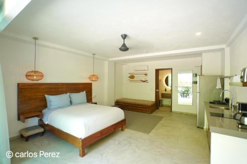 a bedroom with a bed and a kitchen at Hotel Puerto Sayulita in Sayulita