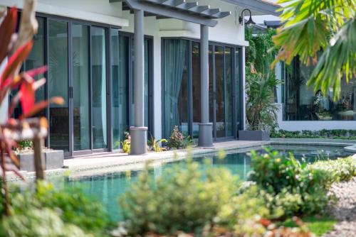 an image of a house with a swimming pool at Tajh Pool Villas in Chalong 