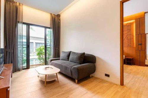 a living room with a couch and a table at Tajh Pool Villas in Chalong 