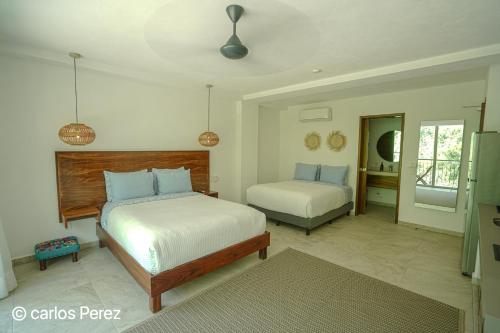 a bedroom with two beds in a room at Hotel Puerto Sayulita in Sayulita