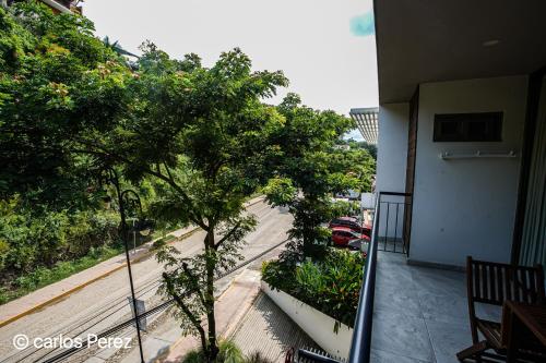 a balcony of a building with a tree and a street at Hotel Puerto Sayulita in Sayulita