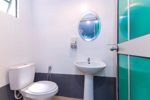 a bathroom with a toilet and a sink at Lotus Hotel Seremban Near Palm Mall & KPJ Seremban in Seremban