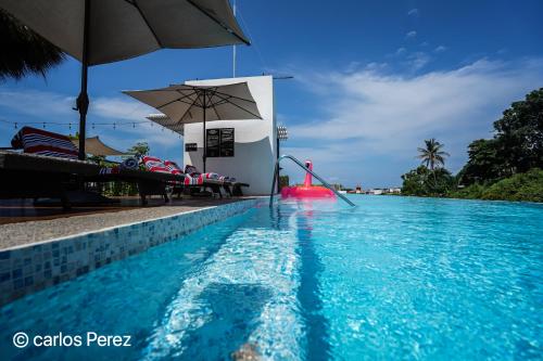 a swimming pool with a red inflatable at Hotel Puerto Sayulita in Sayulita