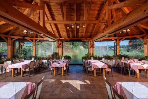 a dining room with tables and chairs in a building at B&B Restoran Bosiljevo in Bosiljevo