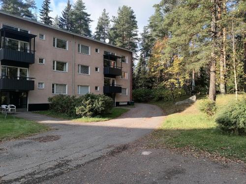 an apartment building with a dirt road in front of it at Apartments 15-20 block D in Kouvola