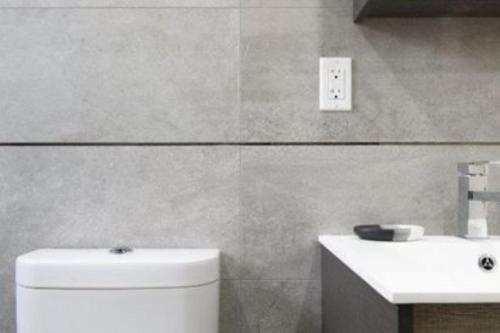 a bathroom with a white toilet and a sink at Magnificent 3 BR Apartment in New York