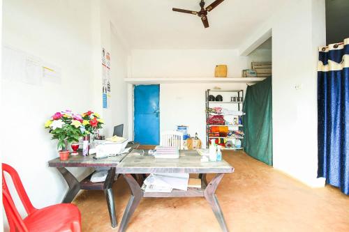 ein Esszimmer mit einem Tisch und einem roten Stuhl in der Unterkunft SPOT ON Krishna Market And Lodge in Sihorā