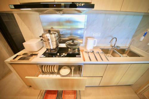 a small kitchen with a stove and a sink at Colorful Yunnan Absolutely Beautiful Dian B&B in Kunming