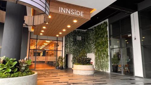 an entrance to an office building with plants at INNSiDE by Meliá Kuala Lumpur in Kuala Lumpur