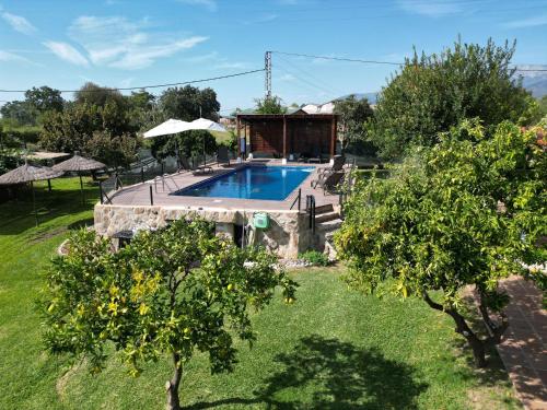 a swimming pool in a yard with trees at La Lagunilla Golf in Candeleda