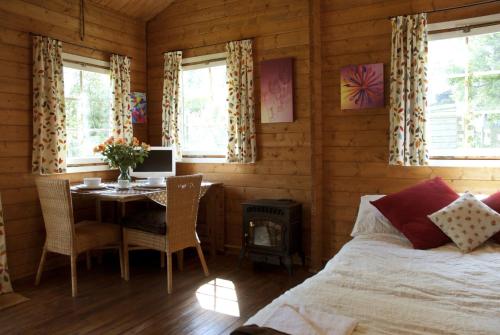 a bedroom with a bed and a table and a stove at ArtHouse B&B in Oakham