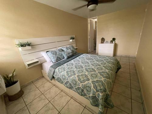 a bedroom with a large bed with a comforter at Paradise Oceanfront Condo - Ocean Is Your Home in Luquillo