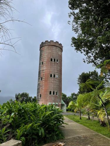 a tall brick tower sitting in the middle of a park at Oceanfront Retreat in Playa Fortuna, Puerto Rico in Luquillo