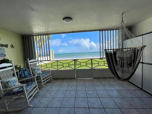 a room with a hammock and a view of the ocean at Oceanfront Retreat in Playa Fortuna, Puerto Rico in Luquillo