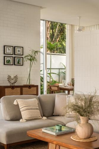 a living room with a couch and a table at La Macedo, Luxury 3 BHK Villas in Assagao, with Private Pool, Garden, Terrace, Parking, Security in Mapusa