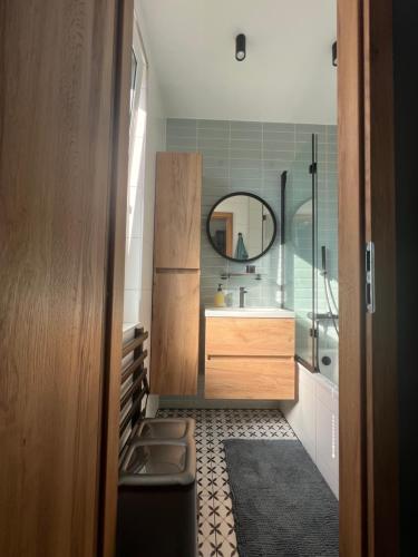 a bathroom with a sink and a mirror at Apartmán pod Lesom Kežmarok in Kežmarok