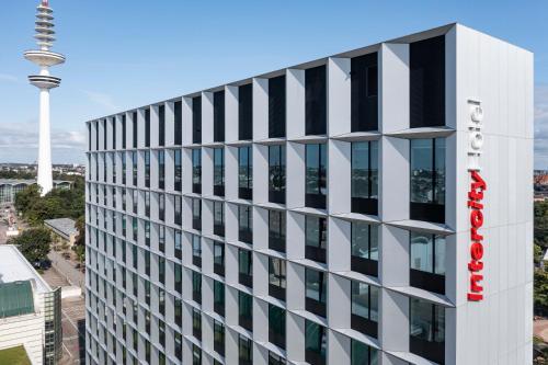 an office building with the space needle in the background at IntercityHotel Hamburg Dammtor-Messe in Hamburg