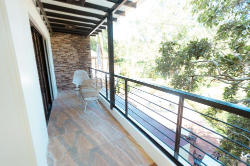 a balcony of a house with a chair on it at Bellagio Hills Hotel and Restaurant in Paoay