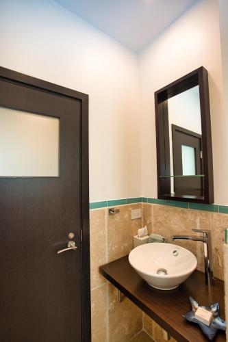 a bathroom with a sink and a mirror at Oceanfront 5-Stars Starfish Villa, Dawn Beach, Private Pool, Secured, Concierge in Oyster Pond