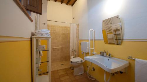 a bathroom with a sink and a toilet and a shower at PODERE BELLARIA 18&2, Emma Villas in Rapolano Terme