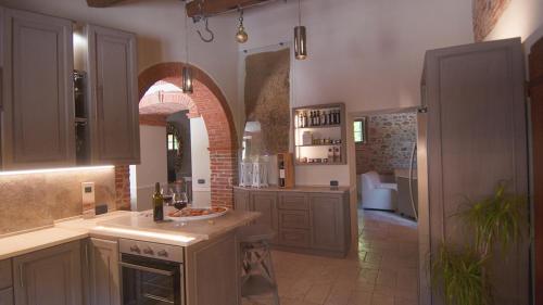 a kitchen with a sink and a counter in a room at PODERE BELLARIA 18&2, Emma Villas in Rapolano Terme